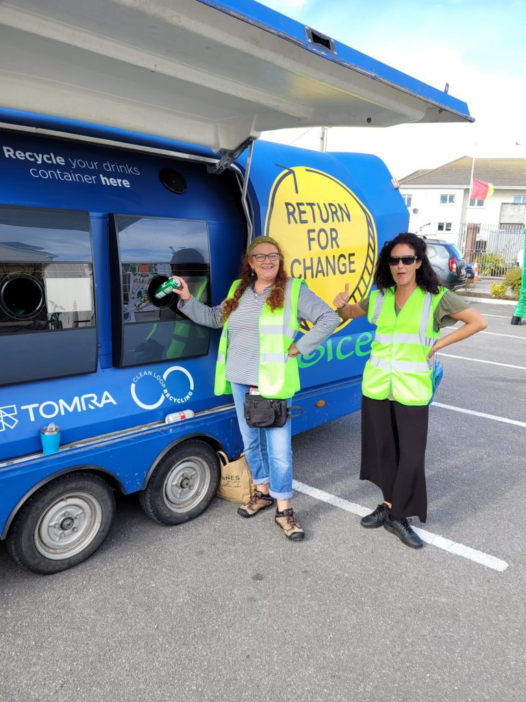 Two women demonstrating use of the Return for Change trailer